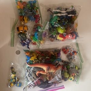 Assorted toy bag action figures and dinosaur